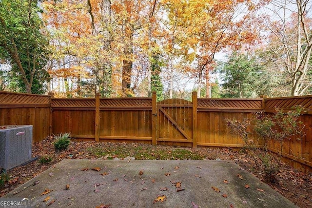 exterior space with cooling unit, a patio area, and a fenced backyard