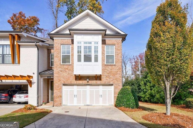 view of front of house with concrete driveway, a garage, and brick siding