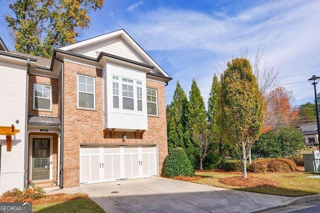 view of front of property featuring concrete driveway, brick siding, and a garage