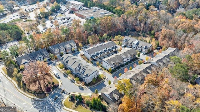 birds eye view of property with a view of trees