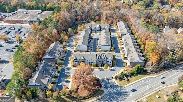 drone / aerial view with a wooded view