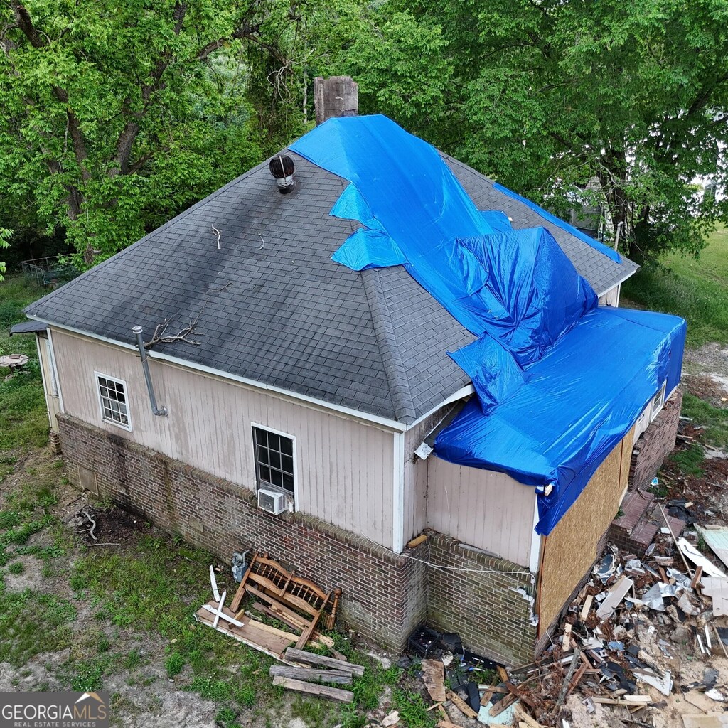 339 Atlanta St, Barnesville, GA 30204 - view of side of property with a shingled roof, cooling unit, and a chimney