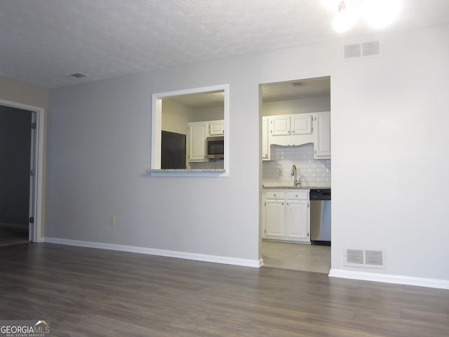 4018 Woodridge Way, Tucker, GA 30084 - unfurnished living room featuring baseboards, visible vents, and wood finished floors