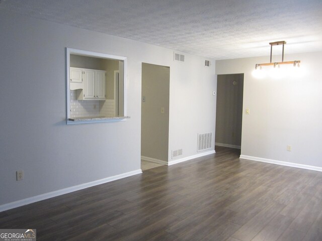 4018 Woodridge Way, Tucker, GA 30084 - spare room with baseboards, visible vents, and dark wood finished floors