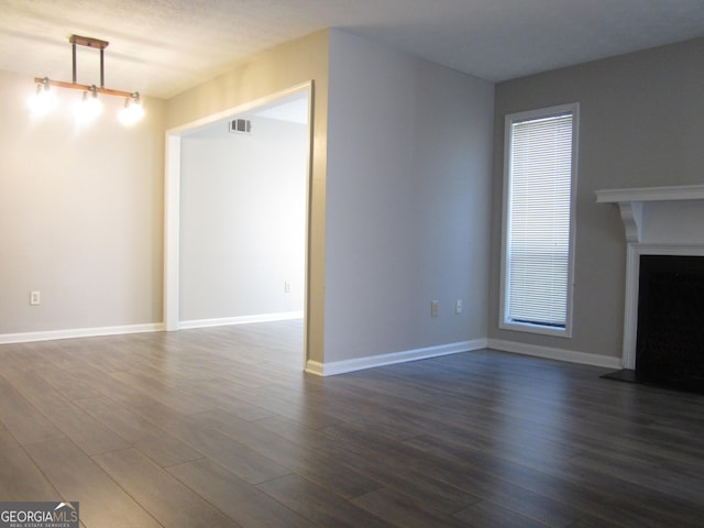 4018 Woodridge Way, Tucker, GA 30084 - unfurnished living room featuring baseboards, a fireplace with raised hearth, and dark wood finished floors