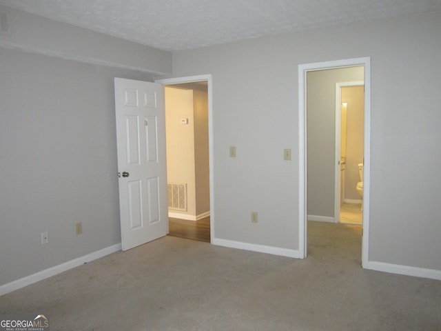 4018 Woodridge Way, Tucker, GA 30084 - unfurnished bedroom featuring carpet flooring, a textured ceiling, visible vents, and baseboards