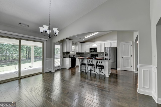 kitchen with black appliances, visible vents, an inviting chandelier, white cabinetry, and dark countertops