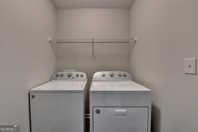 laundry area featuring separate washer and dryer and laundry area