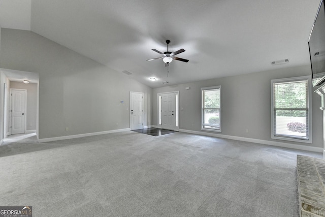 unfurnished living room featuring lofted ceiling, baseboards, ceiling fan, and carpet
