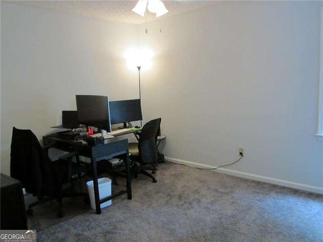 home office featuring carpet flooring, a textured ceiling, baseboards, and ceiling fan