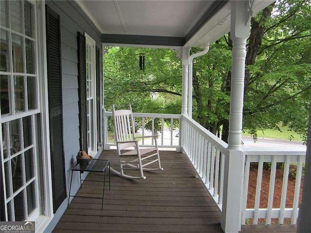 wooden terrace featuring covered porch