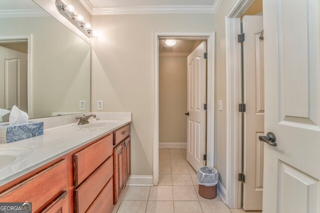 full bath featuring double vanity, ornamental molding, tile patterned floors, and baseboards