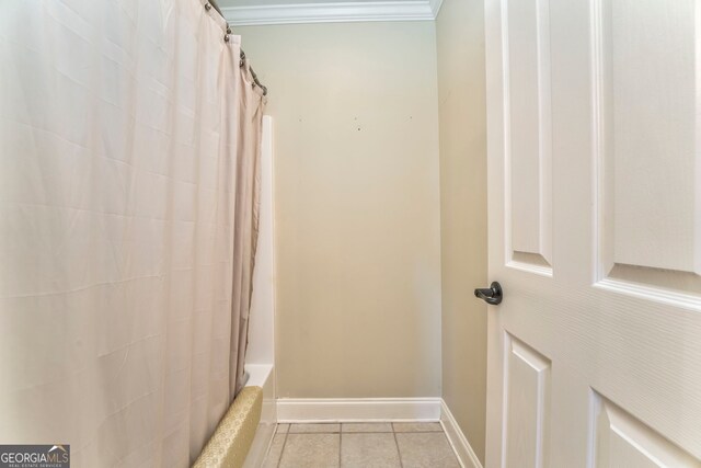 full bathroom with ornamental molding, baseboards, tile patterned flooring, and shower / bath combo