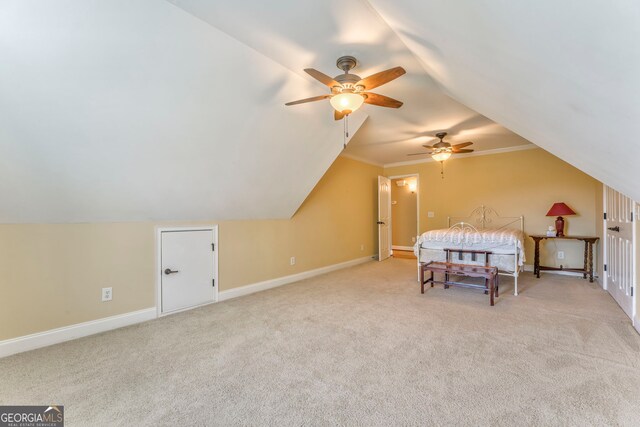 carpeted bedroom featuring lofted ceiling, baseboards, and a ceiling fan
