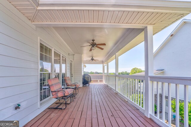wooden terrace featuring ceiling fan