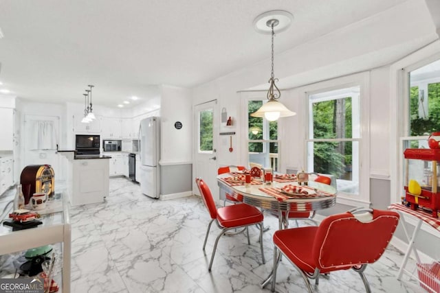 dining space featuring marble finish floor and baseboards