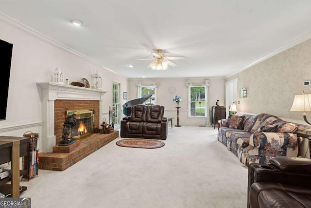 living room with crown molding, a fireplace, ceiling fan, and carpet