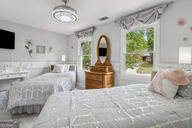 bedroom featuring visible vents and wood finished floors