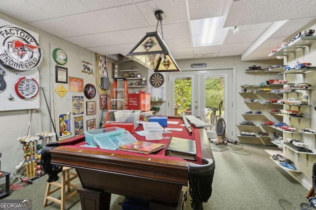 dining area with a drop ceiling and carpet floors