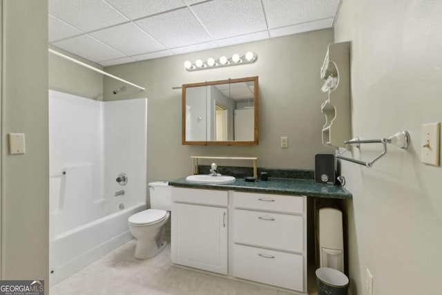 bathroom with toilet, shower / bathtub combination, vanity, tile patterned floors, and a paneled ceiling