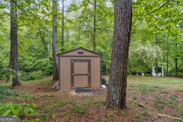 view of shed with a forest view