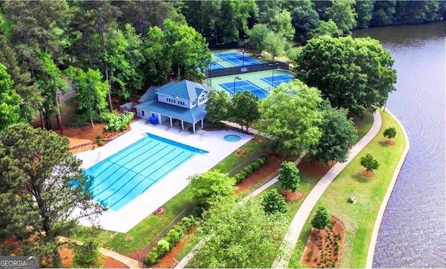 view of subject property with a large body of water and a pool