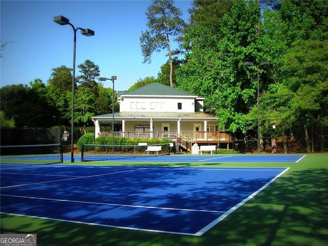 view of tennis court featuring fence