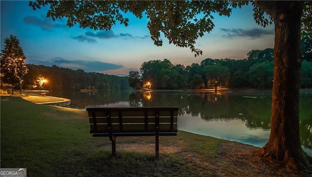 view of property's community featuring a water view and a wooded view