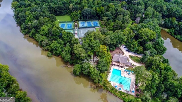 aerial view of property's location featuring a pool and a large body of water