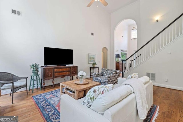 295 River Laurel Way, Woodstock, GA 30188 - living area featuring arched walkways, stairway, visible vents, and a ceiling fan