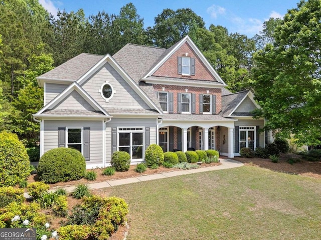 295 River Laurel Way, Woodstock, GA 30188 - view of front facade featuring covered porch, roof with shingles, and a front yard