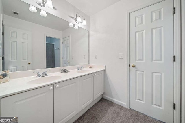295 River Laurel Way, Woodstock, GA 30188 - bathroom with baseboards, visible vents, double vanity, and a sink