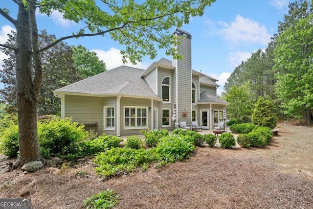 295 River Laurel Way, Woodstock, GA 30188 - rear view of house with a chimney and a patio area