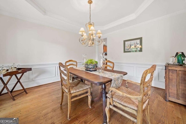 295 River Laurel Way, Woodstock, GA 30188 - dining space featuring wainscoting, ornamental molding, light wood-type flooring, a tray ceiling, and a notable chandelier
