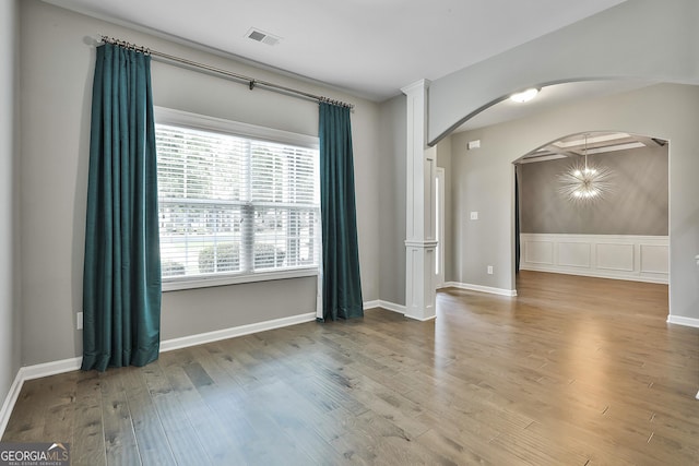 70 Pacific Ave, Sharpsburg, GA 30277 - unfurnished room with arched walkways, wood finished floors, and baseboards