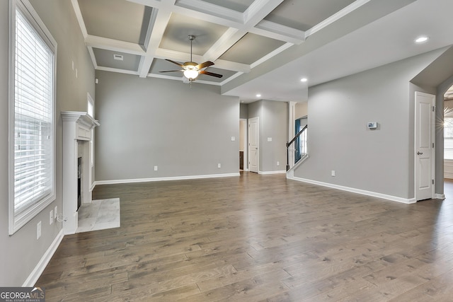 70 Pacific Ave, Sharpsburg, GA 30277 - unfurnished living room with a ceiling fan, a premium fireplace, beamed ceiling, coffered ceiling, and baseboards