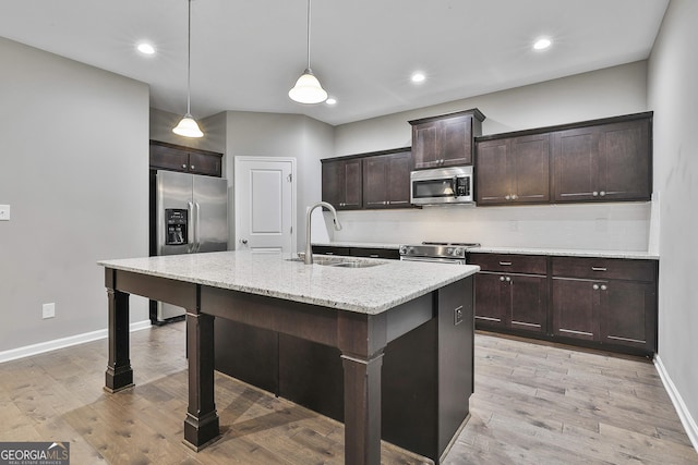 70 Pacific Ave, Sharpsburg, GA 30277 - kitchen with a sink, stainless steel appliances, a breakfast bar area, baseboards, and dark brown cabinets