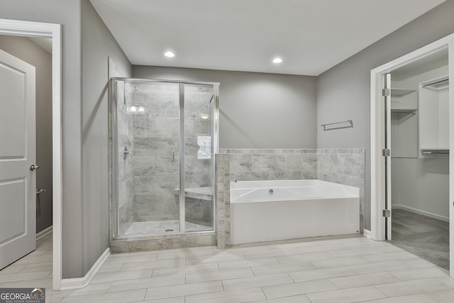 70 Pacific Ave, Sharpsburg, GA 30277 - full bathroom with a shower stall, a bath, recessed lighting, and baseboards