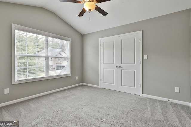 70 Pacific Ave, Sharpsburg, GA 30277 - unfurnished bedroom with vaulted ceiling, carpet, baseboards, a closet, and ceiling fan