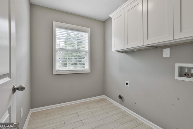 70 Pacific Ave, Sharpsburg, GA 30277 - washroom with hookup for an electric dryer, cabinet space, baseboards, hookup for a washing machine, and light wood-type flooring