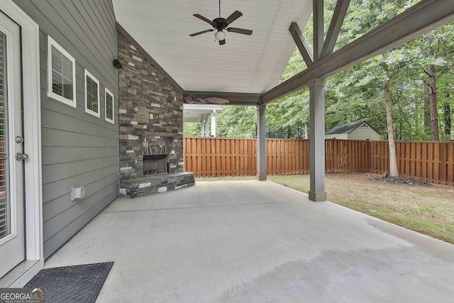 70 Pacific Ave, Sharpsburg, GA 30277 - view of patio / terrace featuring an outdoor stone fireplace, fence, and a ceiling fan