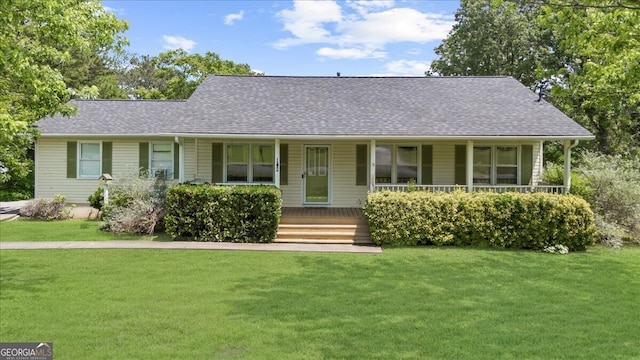142 Poplar St SW, Calhoun, GA 30701 - view of front facade with covered porch, a shingled roof, and a front yard