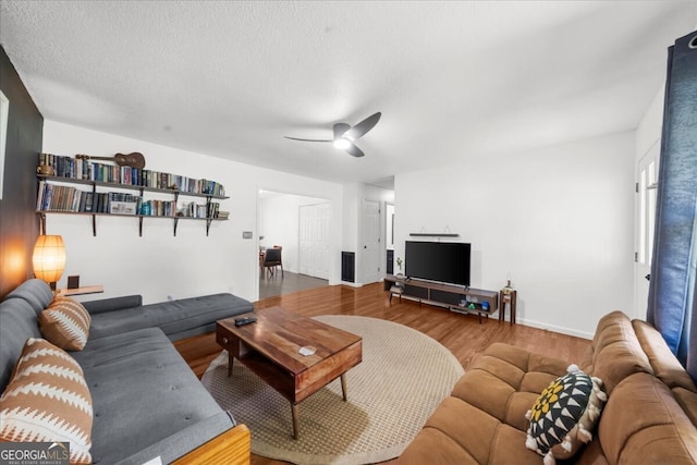 142 Poplar St SW, Calhoun, GA 30701 - living room with ceiling fan, a textured ceiling, baseboards, and wood finished floors