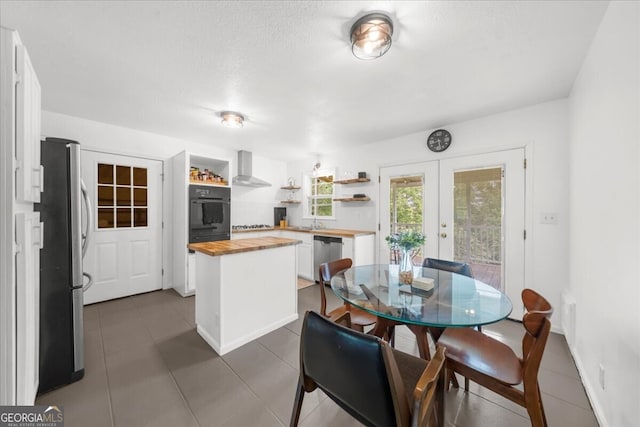 142 Poplar St SW, Calhoun, GA 30701 - dining room with dark tile patterned floors and french doors