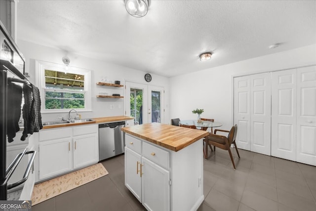 142 Poplar St SW, Calhoun, GA 30701 - kitchen with refrigerator, a sink, white cabinetry, dishwasher, and butcher block counters