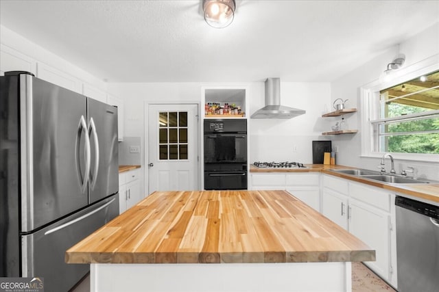 142 Poplar St SW, Calhoun, GA 30701 - kitchen with wood counters, stainless steel appliances, open shelves, and wall chimney range hood