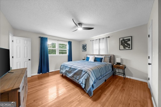 142 Poplar St SW, Calhoun, GA 30701 - bedroom with light wood-type flooring, baseboards, a ceiling fan, and a textured ceiling