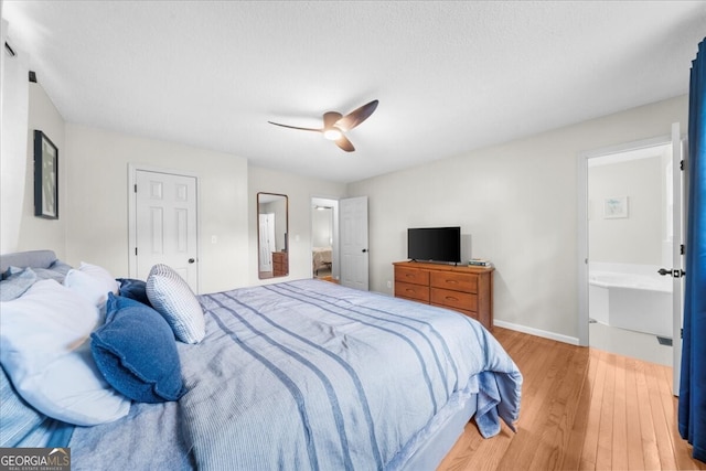 142 Poplar St SW, Calhoun, GA 30701 - bedroom with a ceiling fan, baseboards, ensuite bath, and light wood-style flooring