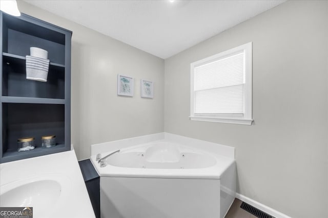 142 Poplar St SW, Calhoun, GA 30701 - full bath with a tub with jets, vanity, and visible vents