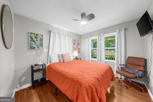 142 Poplar St SW, Calhoun, GA 30701 - bedroom with wood finished floors, baseboards, and a textured ceiling
